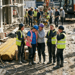 Group of female construction workers comforting a crying coworker at a construction site